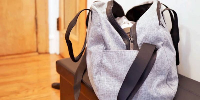 A view of a grey sports bag on a bench in a room