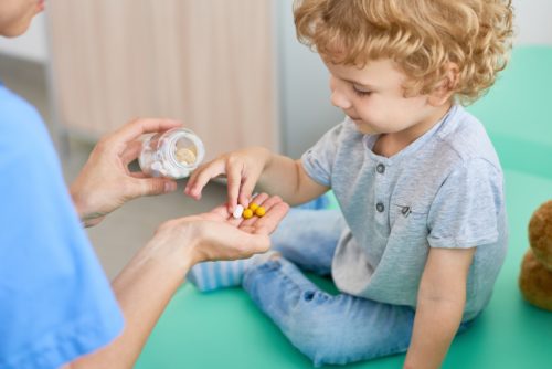 Kid taking a supplement