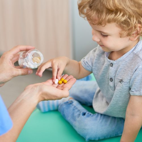 Kid taking a supplement